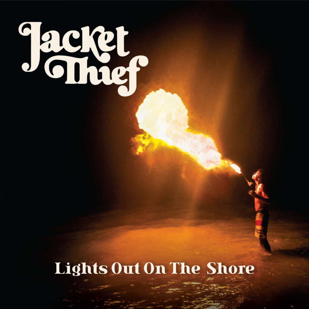 jacket thief lights out on the shore album cover with a fire eater in the dark.