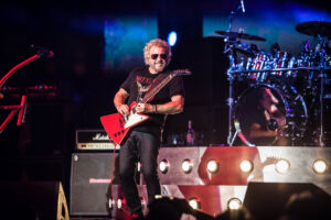 Sammy Hagar on stage playing a res gibson explorer guitar.